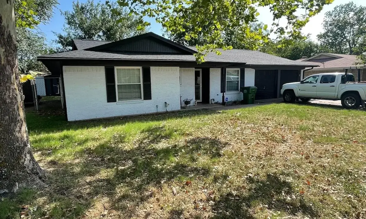 Professional roofing crew working on a residential roof in Avon